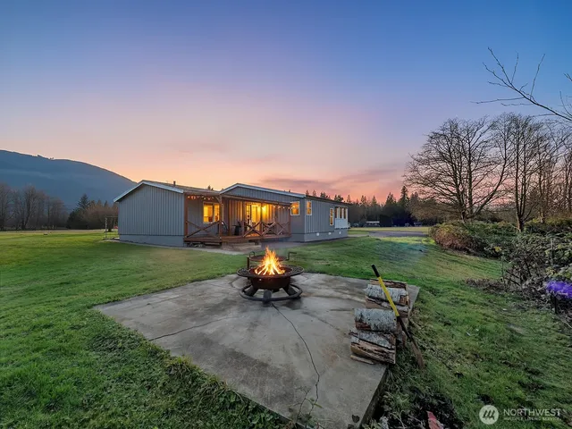 a backyard of a house with table and chairs