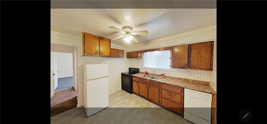 3204 Universal Road Pittsburgh, PA 15235 - Photo 4 of 12 a kitchen with stainless steel appliances granite countertop a stove a refrigerator and a cabinets