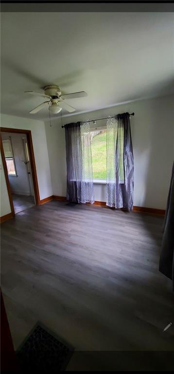 3204 Universal Road Pittsburgh, PA 15235 - Photo 5 of 12 an empty room with wooden floor and windows