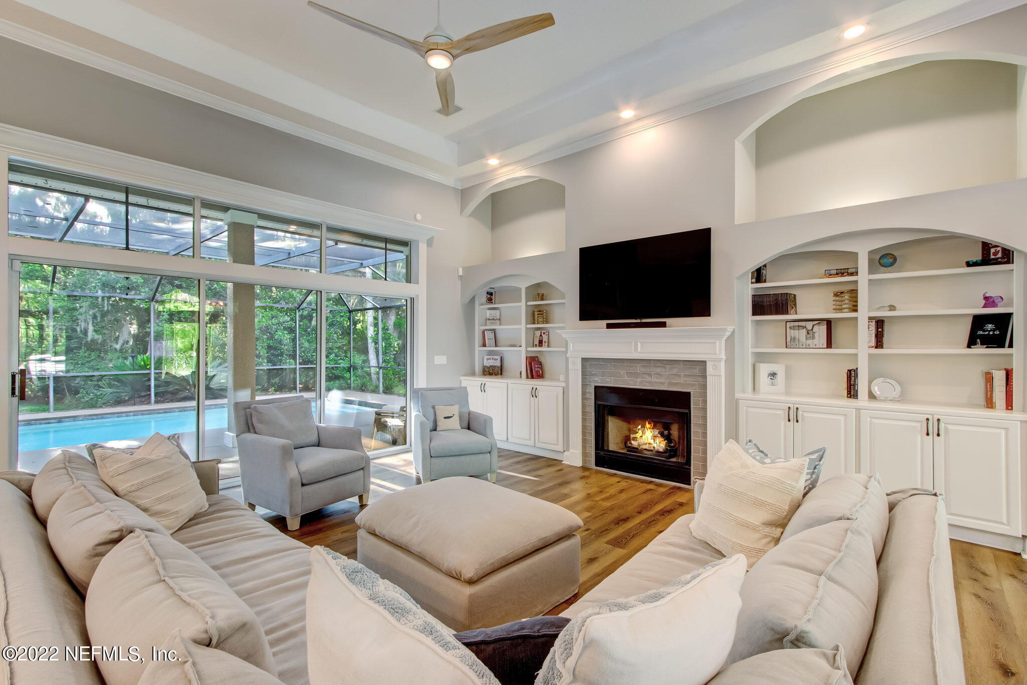 772 Mill Stream Road Ponte Vedra Beach, FL 32082 - Photo 55 of 57 a living room with furniture a fireplace and a flat screen tv
