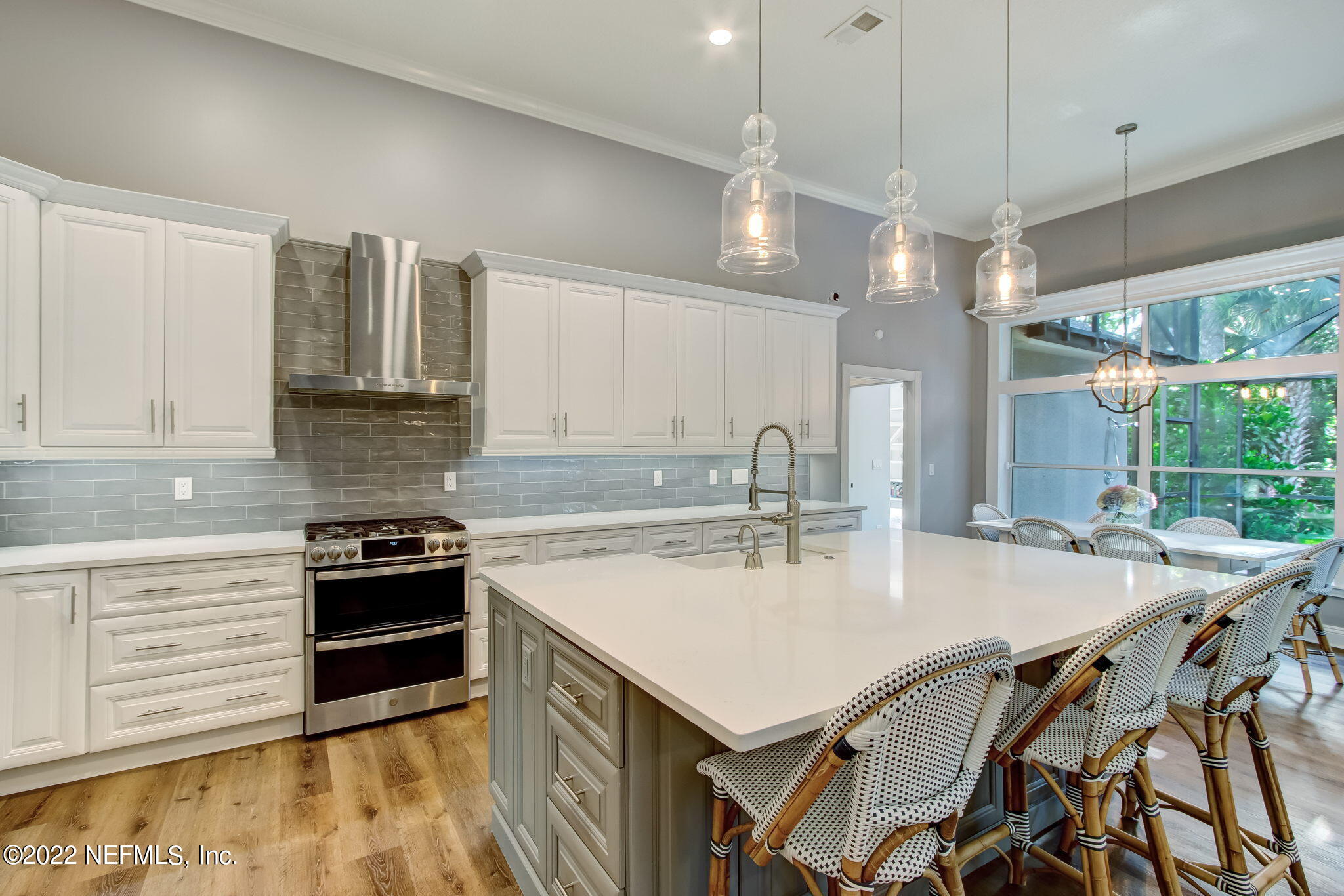 772 Mill Stream Road Ponte Vedra Beach, FL 32082 - Photo 19 of 57 a kitchen with a table chairs stove and kitchen island