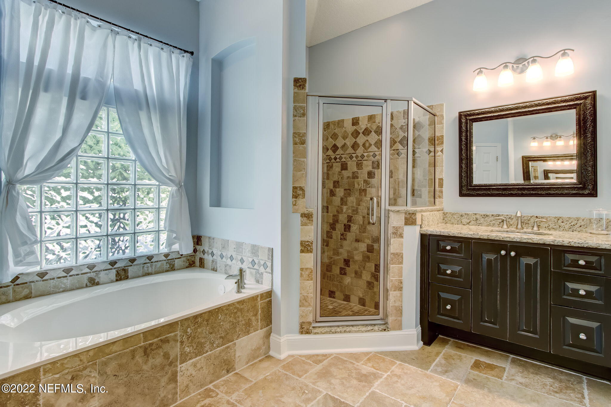 772 Mill Stream Road Ponte Vedra Beach, FL 32082 - Photo 25 of 57 a spacious bathroom with a granite countertop sink mirror and a bathtub