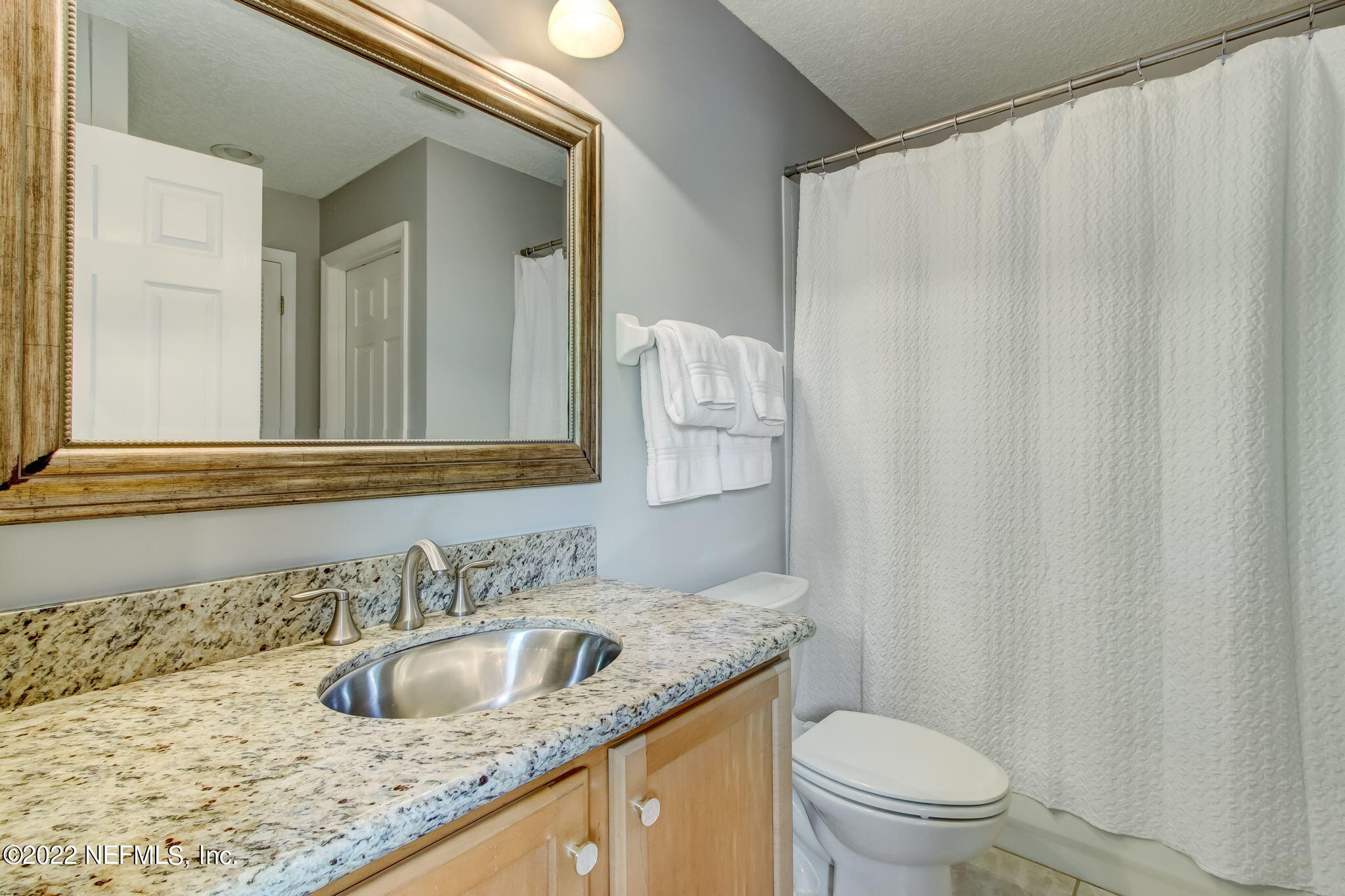 772 Mill Stream Road Ponte Vedra Beach, FL 32082 - Photo 33 of 57 a bathroom with a granite countertop sink and a mirror