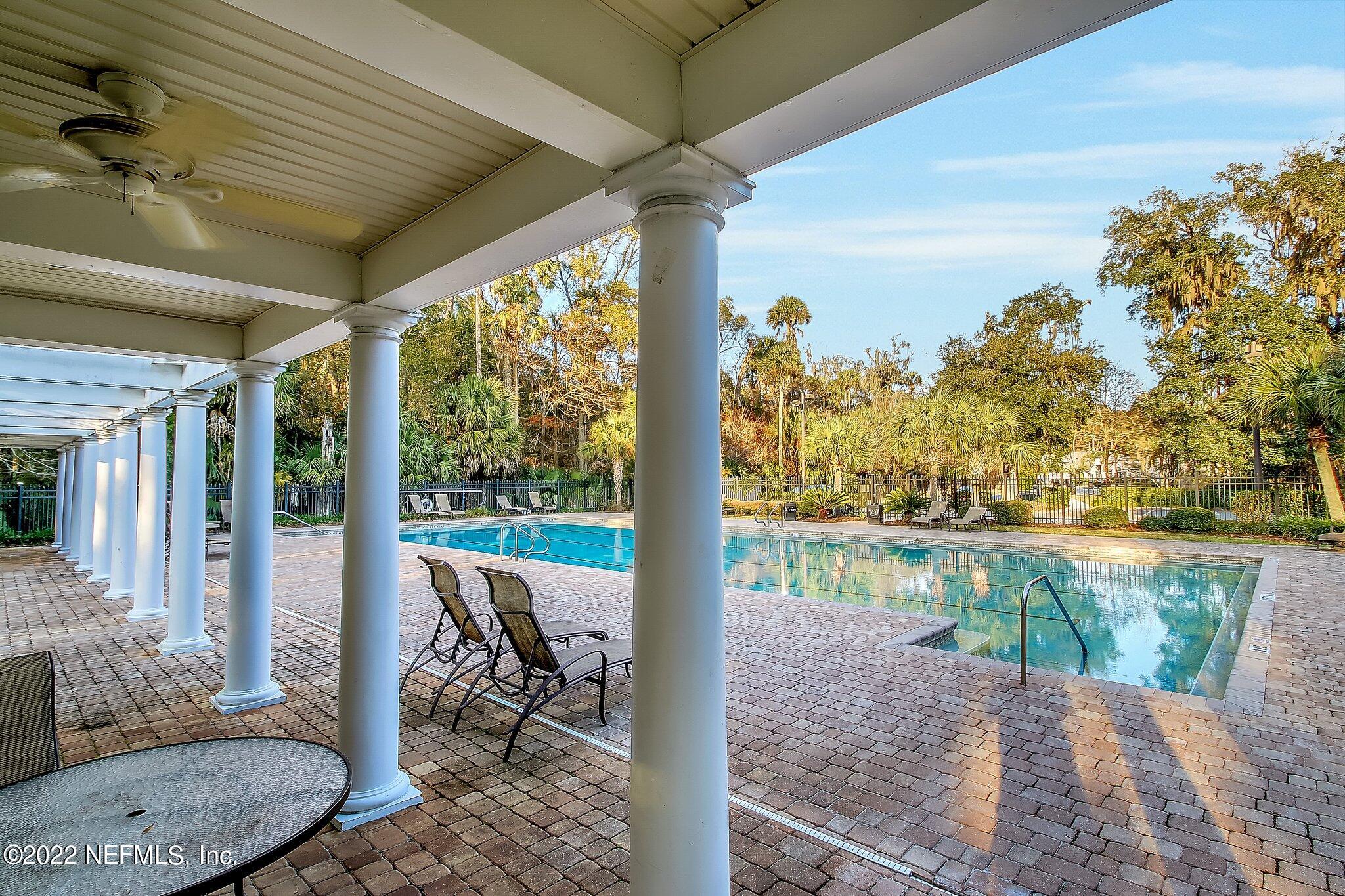 772 Mill Stream Road Ponte Vedra Beach, FL 32082 - Photo 47 of 57 a view of a patio with lawn chairs next to a yard