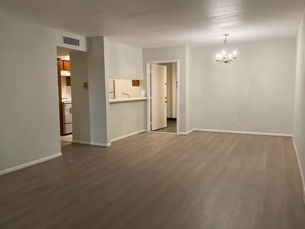 an empty room with closet and a bathroom