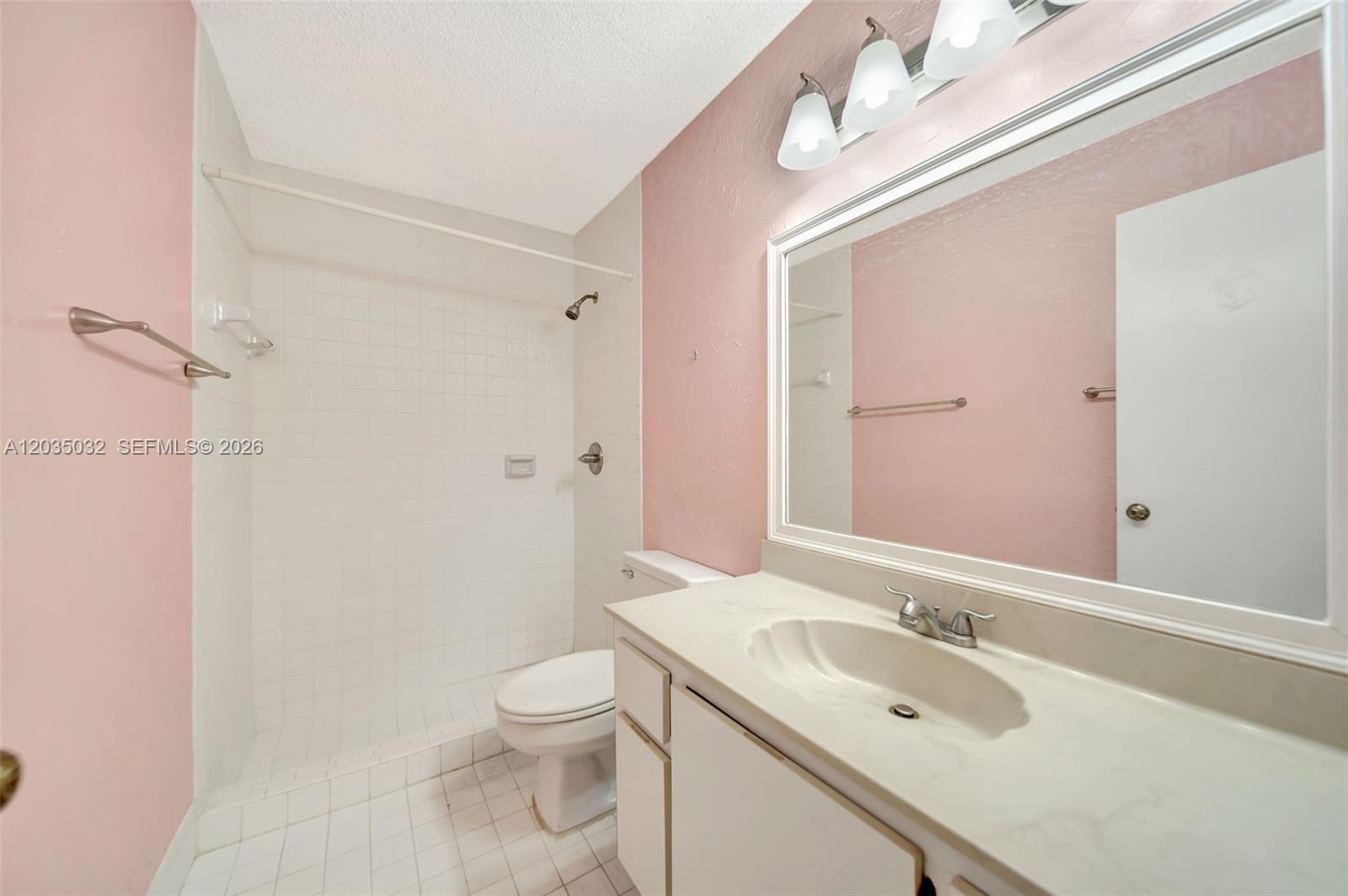 5223 Gate Lake Road, Unit 5223 Tamarac, FL 33319 - Photo 3 of 37 a bathroom with a sink a toilet and shower