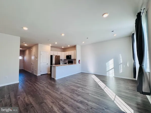 a view of kitchen with cabinets and wooden floor