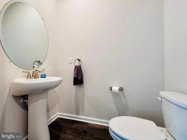 a bathroom with a sink a toilet and mirror
