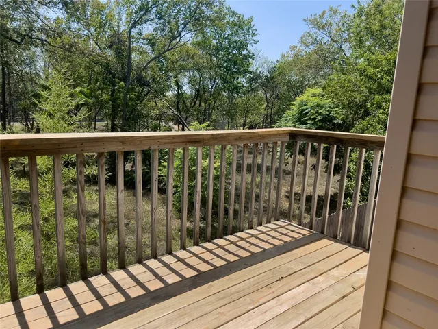 a view of balcony with wooden floor