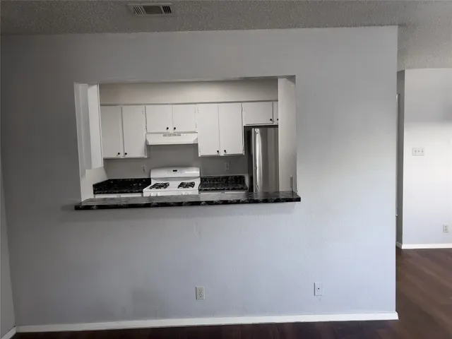a kitchen with a sink and a stove top oven