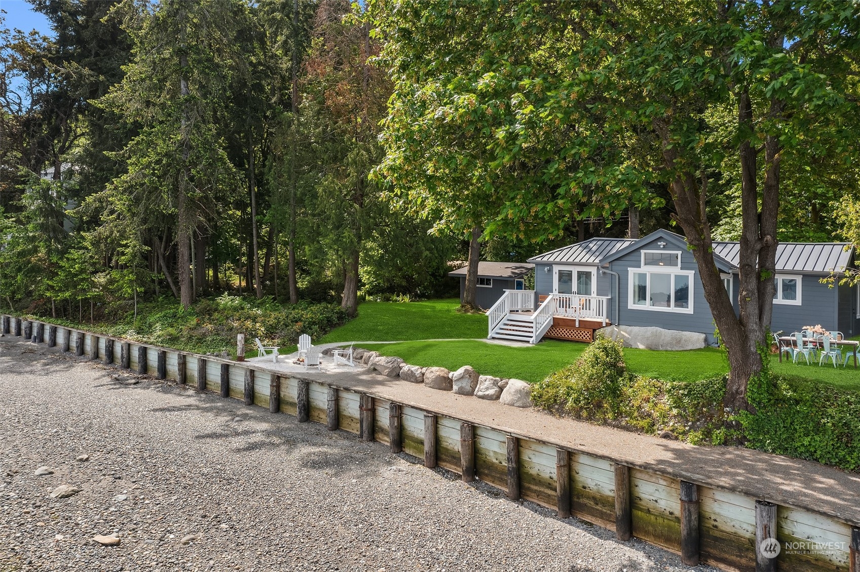 4528 Southwest Luana Beach Road Vashon, WA 98070 - Photo 1 of 27 a front view of a house with yard and green space