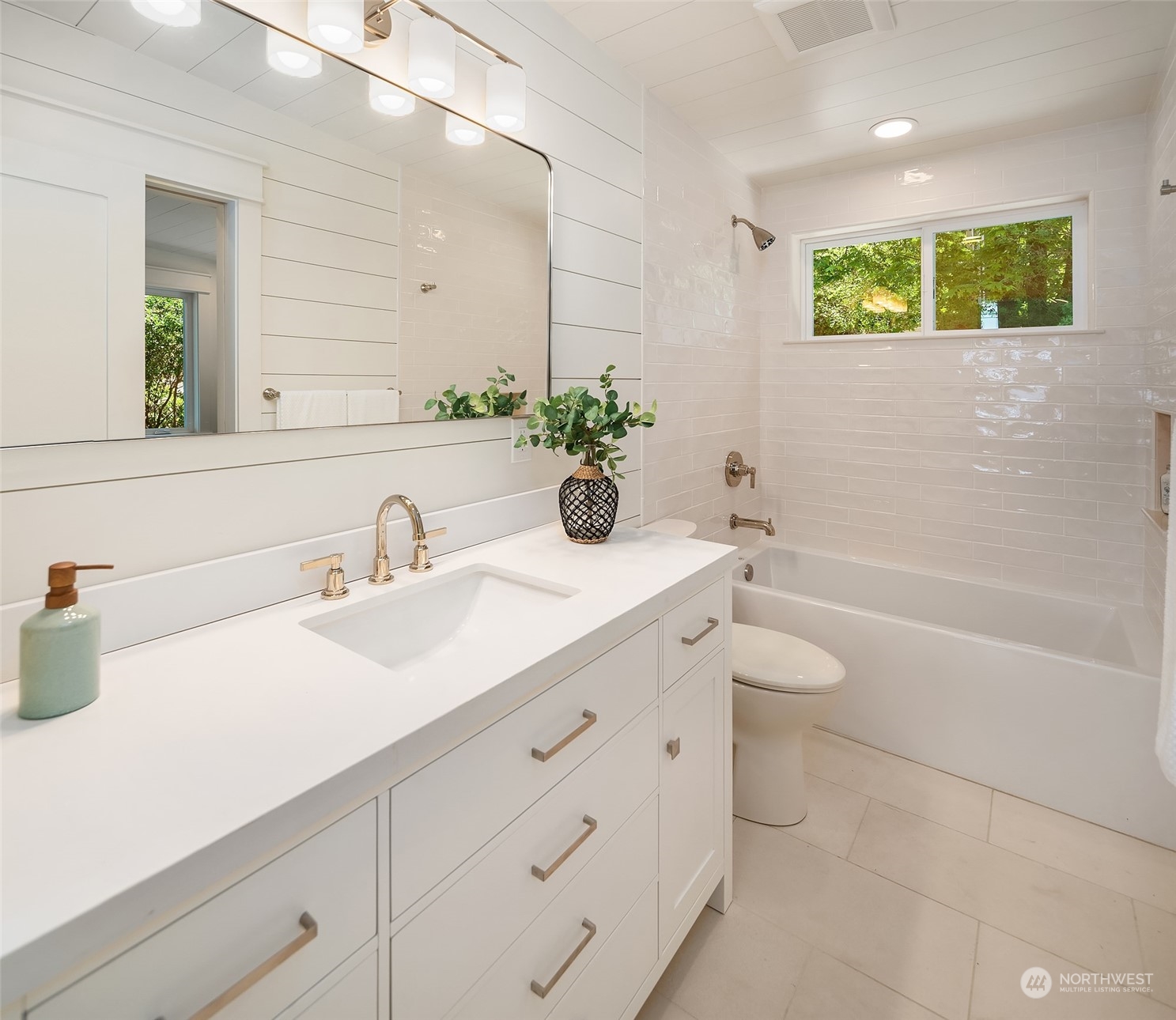 4528 Southwest Luana Beach Road Vashon, WA 98070 - Photo 16 of 27 a bathroom with a double vanity sink and a bathtub