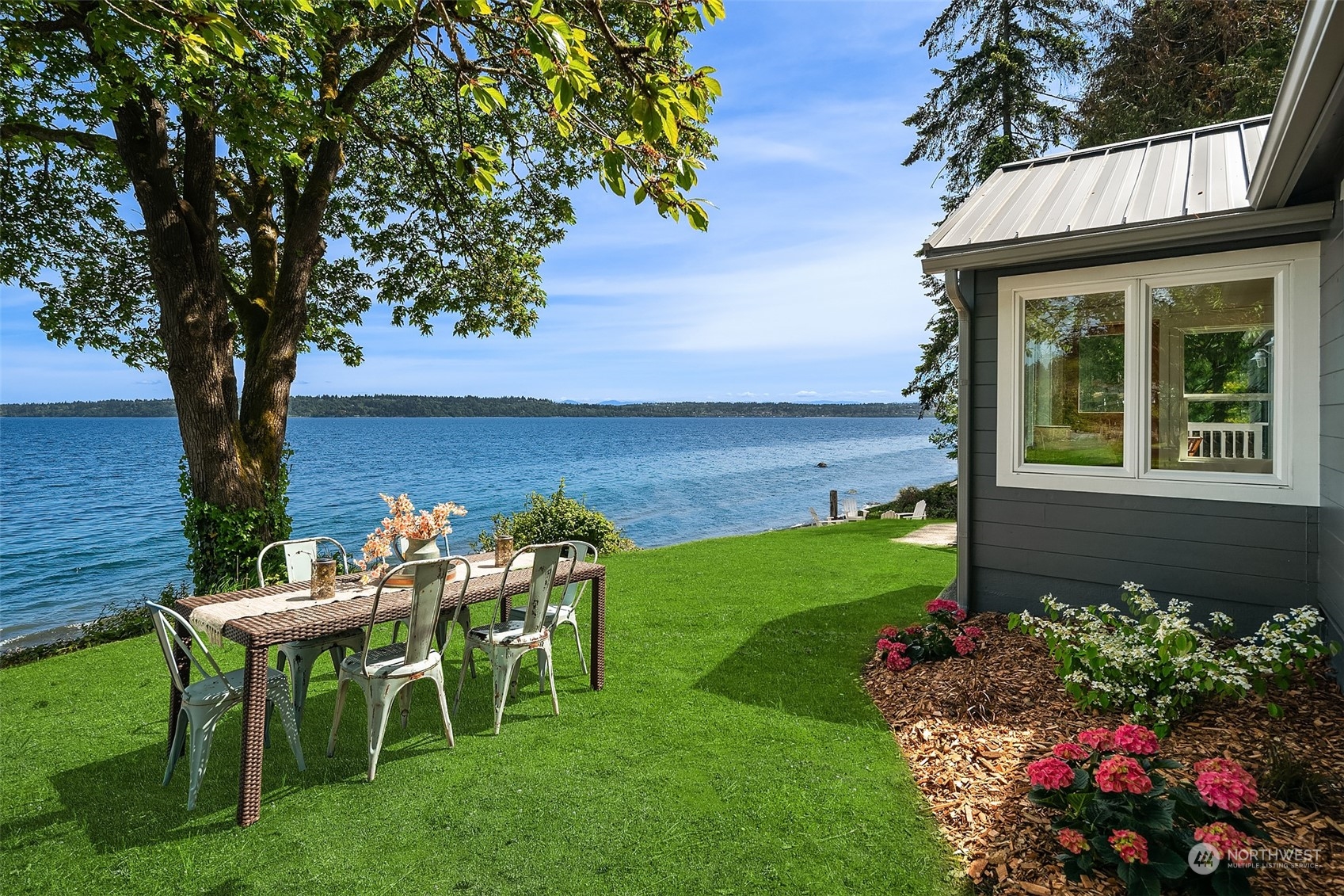 4528 Southwest Luana Beach Road Vashon, WA 98070 - Photo 3 of 27 a view of a chair and table in the garden and yard