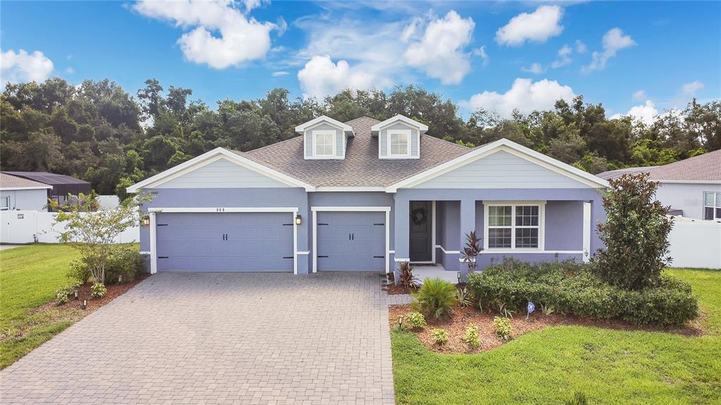 808 Rominger Loop Apopka, FL 32712 - Photo 1 of 1 a front view of a house with a garden and plants