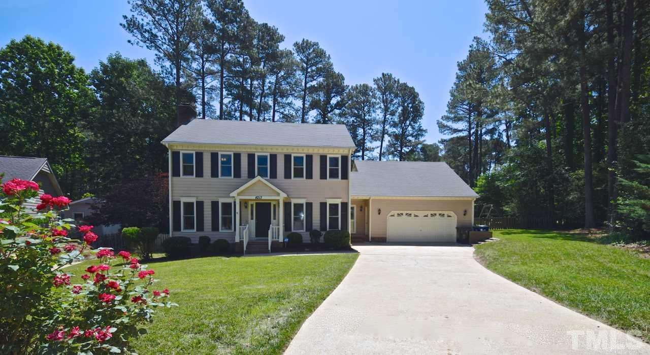 4213 Tolchester Place Raleigh, NC 27613 - Photo 1 of 25 a front view of a house with a yard and garden