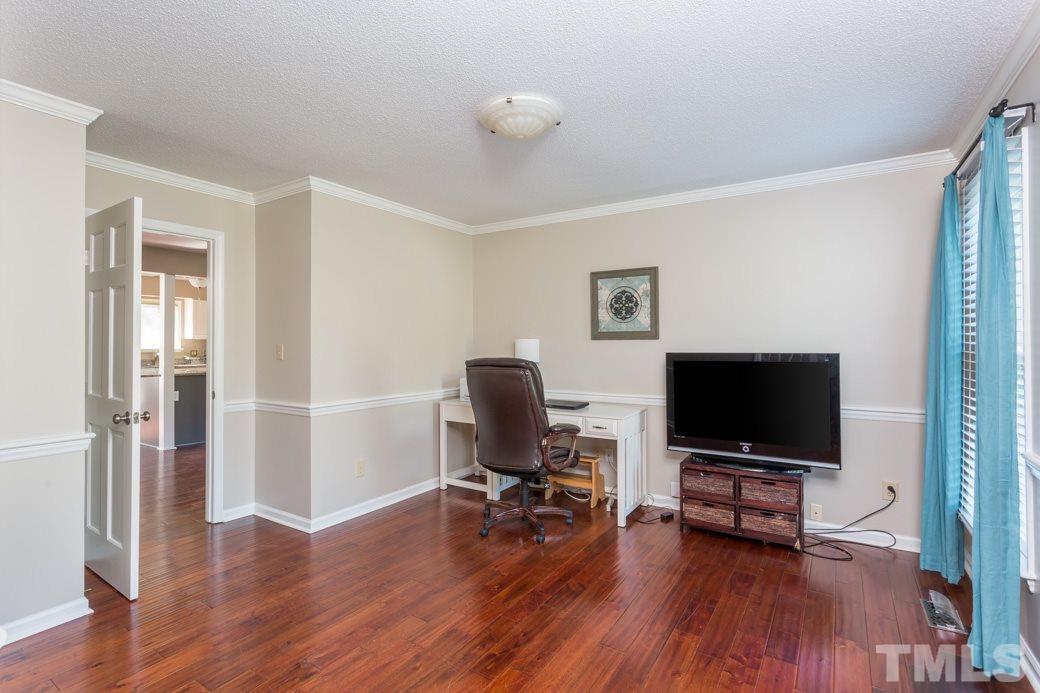 4213 Tolchester Place Raleigh, NC 27613 - Photo 11 of 25 a view of a workspace with furniture and wooden floor