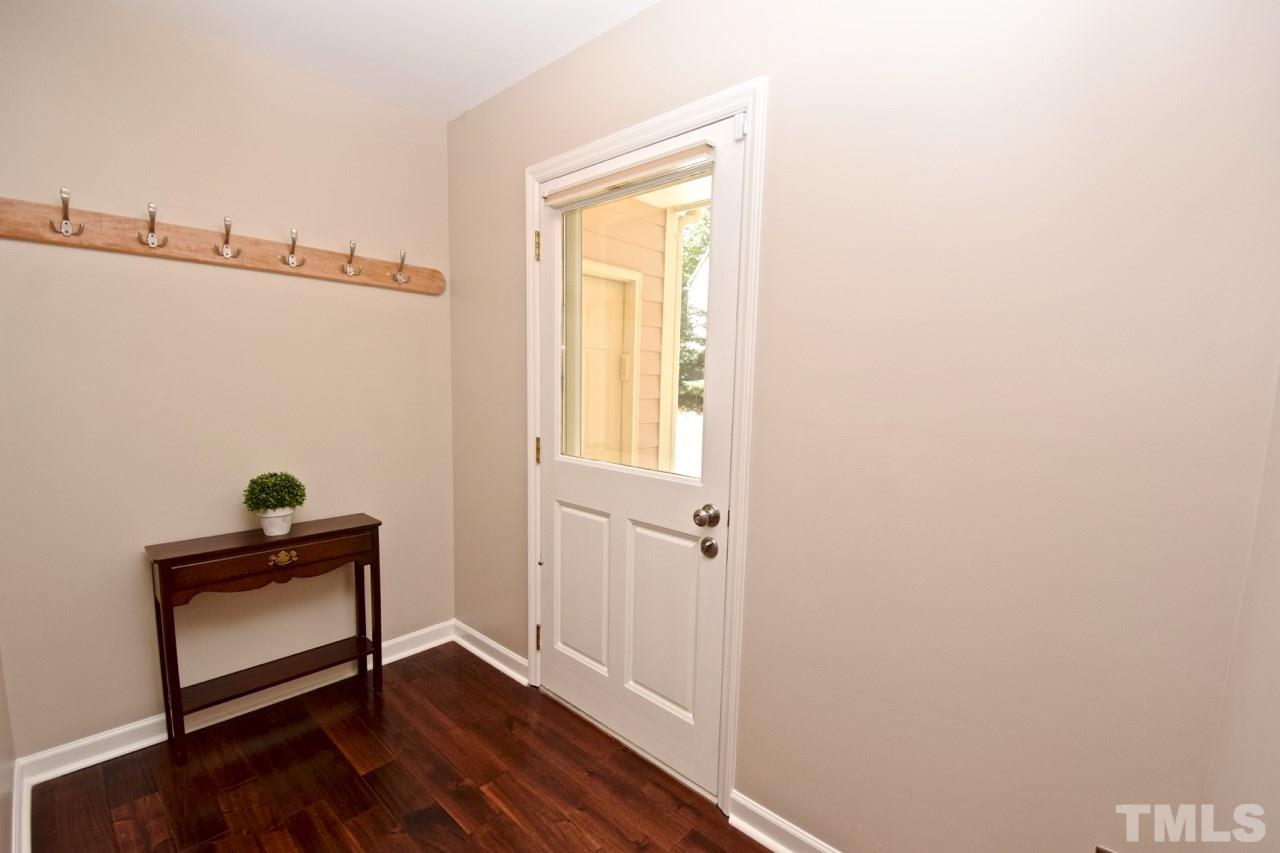 4213 Tolchester Place Raleigh, NC 27613 - Photo 12 of 25 a view of empty room with wooden floor and fan
