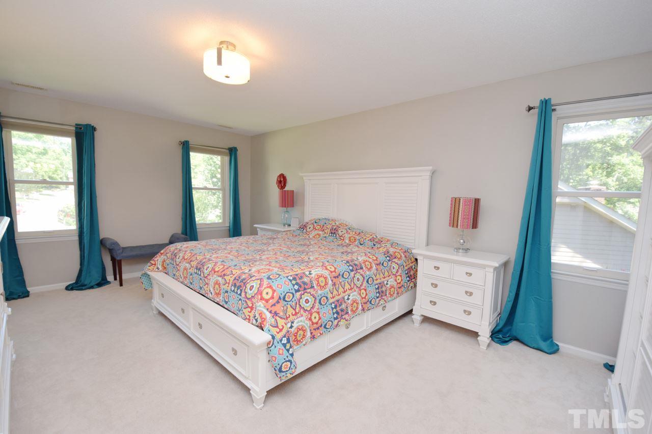 4213 Tolchester Place Raleigh, NC 27613 - Photo 13 of 25 a bedroom with a bed and window