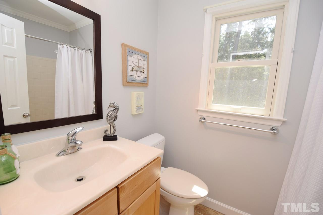 4213 Tolchester Place Raleigh, NC 27613 - Photo 17 of 25 a bathroom with a sink and a toilet