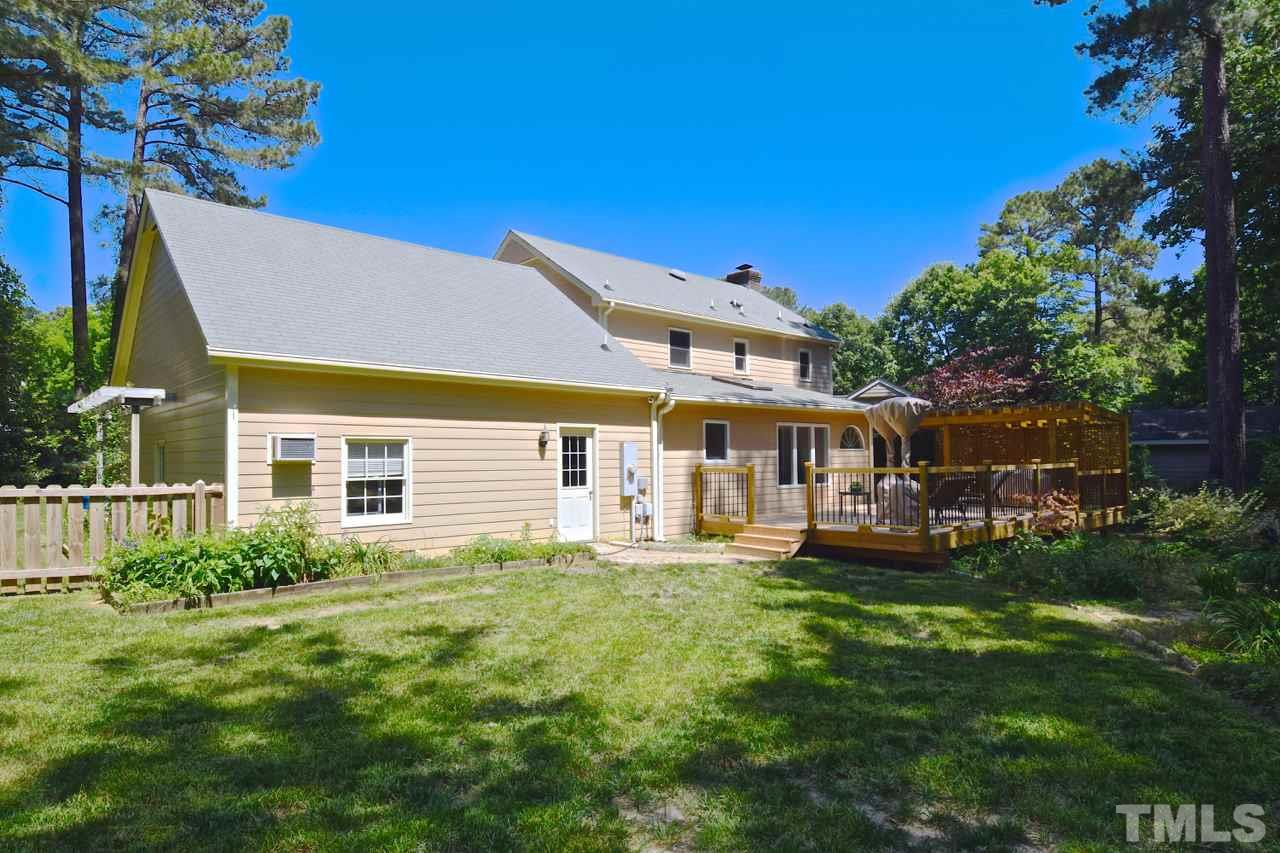 4213 Tolchester Place Raleigh, NC 27613 - Photo 21 of 25 a front view of a house with a yard table and chairs
