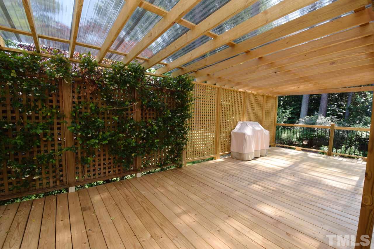 4213 Tolchester Place Raleigh, NC 27613 - Photo 22 of 25 a view of a room with wooden floor and fence