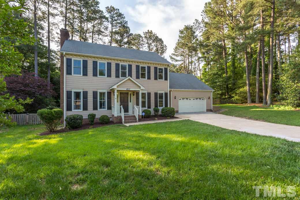 4213 Tolchester Place Raleigh, NC 27613 - Photo 25 of 25 a front view of a house with a garden and porch