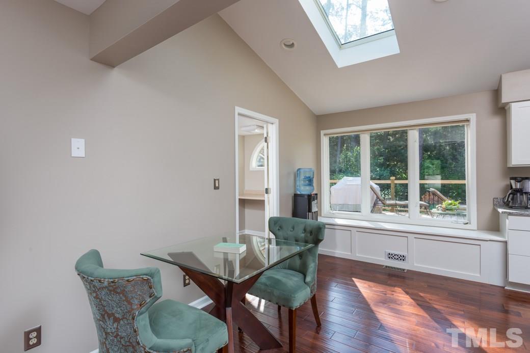 4213 Tolchester Place Raleigh, NC 27613 - Photo 6 of 25 a view of a dining room with furniture window and wooden floor