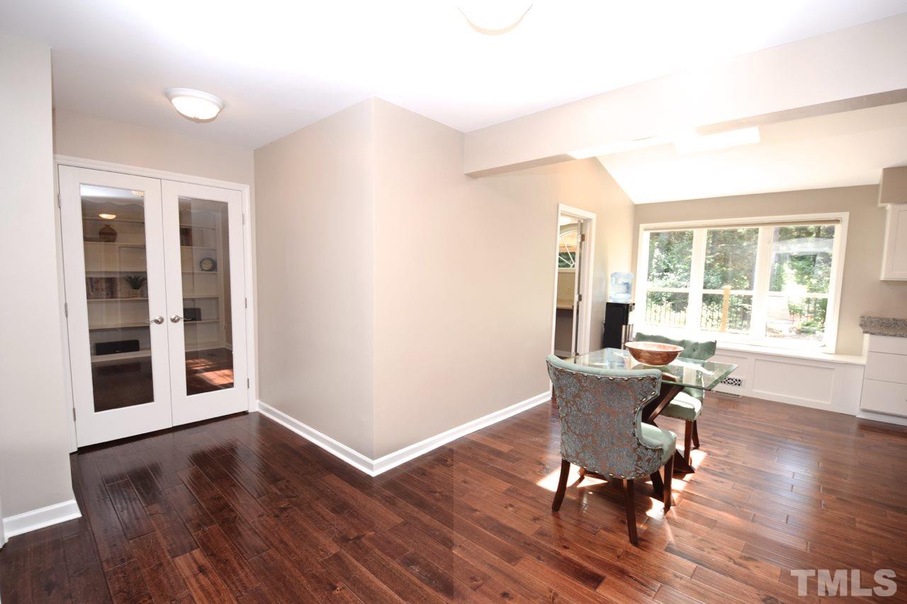 4213 Tolchester Place Raleigh, NC 27613 - Photo 7 of 25 a workspace with wooden floor and a window