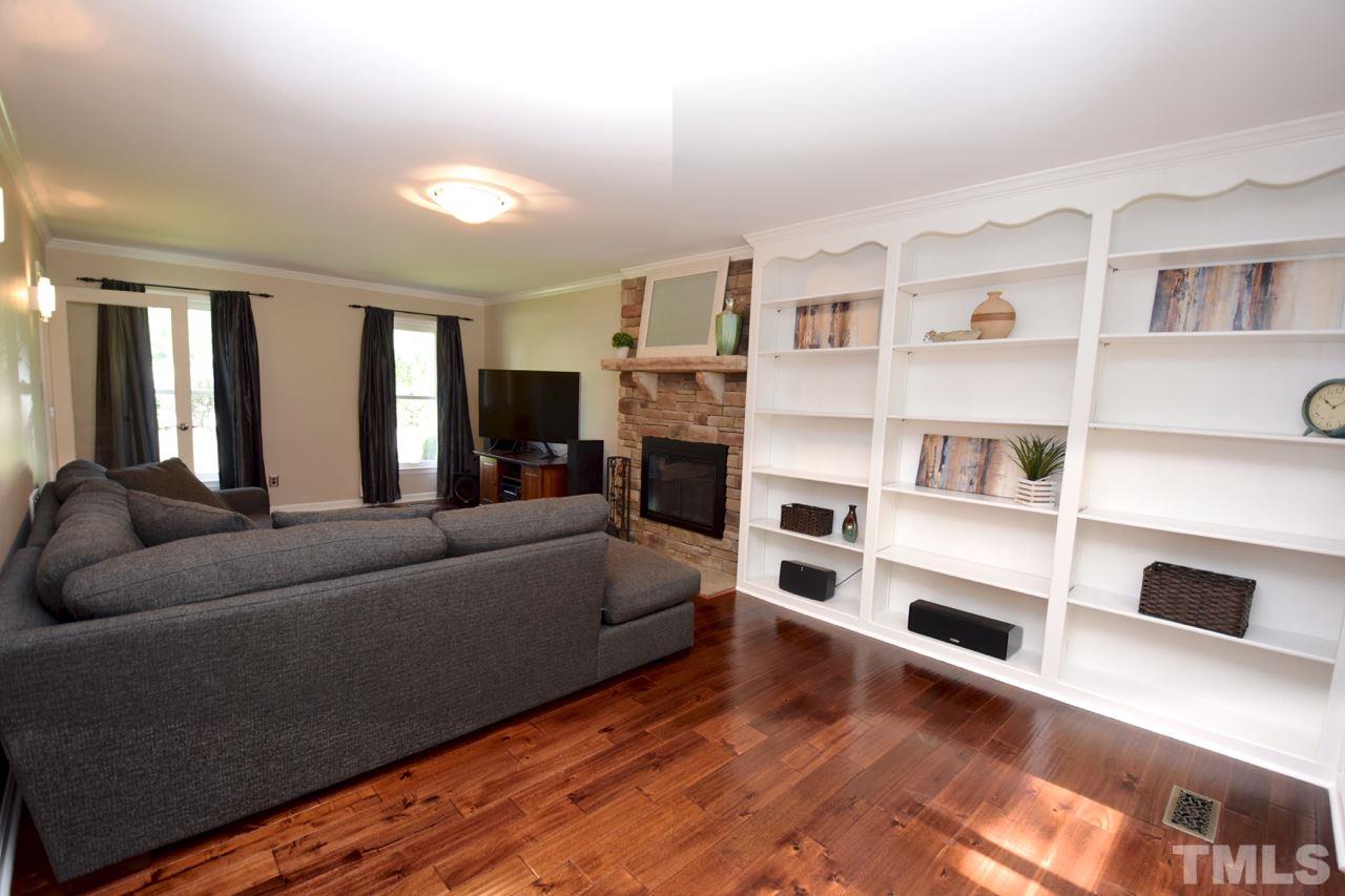 4213 Tolchester Place Raleigh, NC 27613 - Photo 8 of 25 a living room with furniture and a flat screen tv
