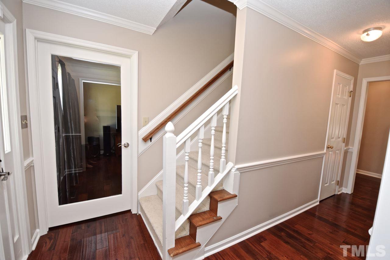 4213 Tolchester Place Raleigh, NC 27613 - Photo 10 of 25 a view of an entryway with wooden floor and door