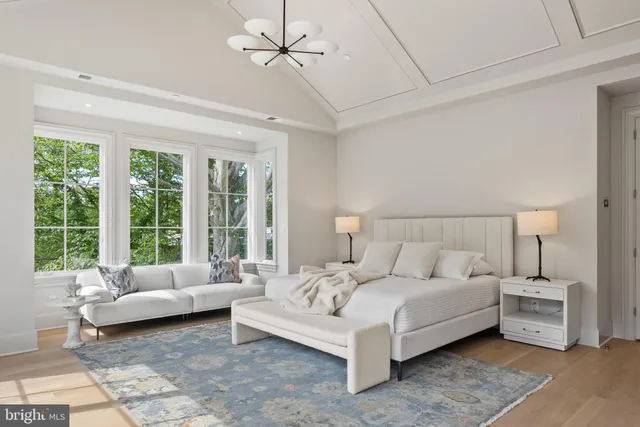 a spacious bedroom with a bed and a large window