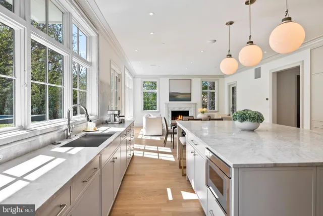 a large kitchen with kitchen island granite countertop a sink and a large window