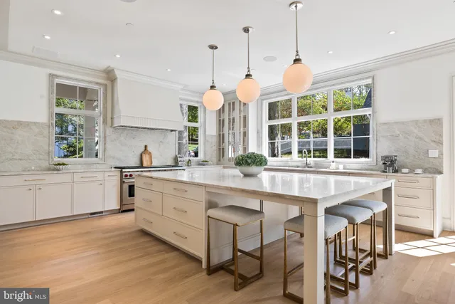 a large kitchen with a large window and stainless steel appliances