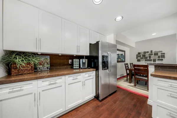 a kitchen with stainless steel appliances granite countertop a refrigerator and stove