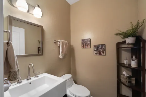 a bathroom with a toilet sink and mirror