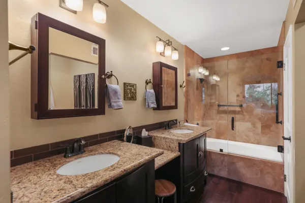 a bathroom with a granite countertop sink mirror and double