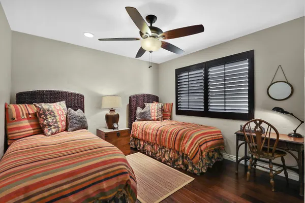 a bedroom with two beds and a large window