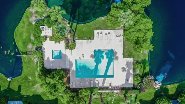 an aerial view of a house with garden space and street view