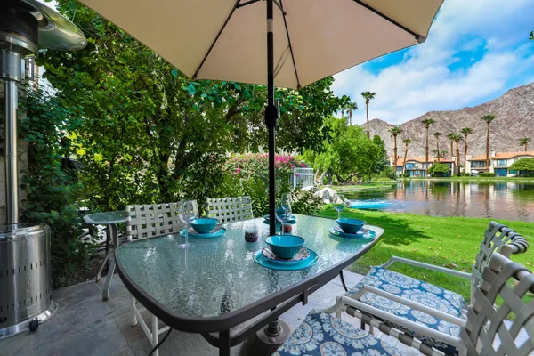 a view of a table and chairs under an umbrella
