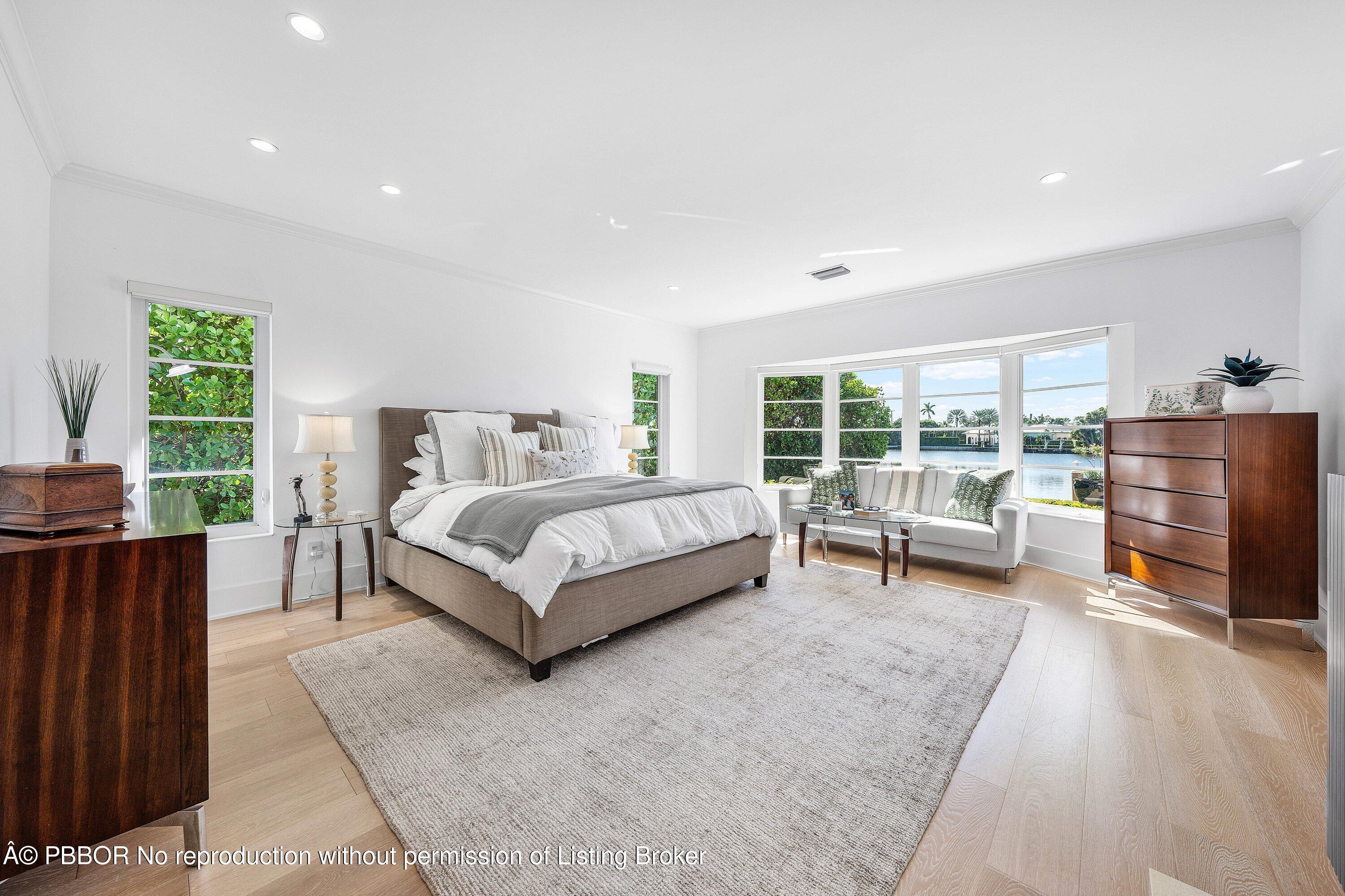 50 Spoonbill Road Lantana, FL 33462 - Photo 15 of 37 a spacious bedroom with a bed and a couch