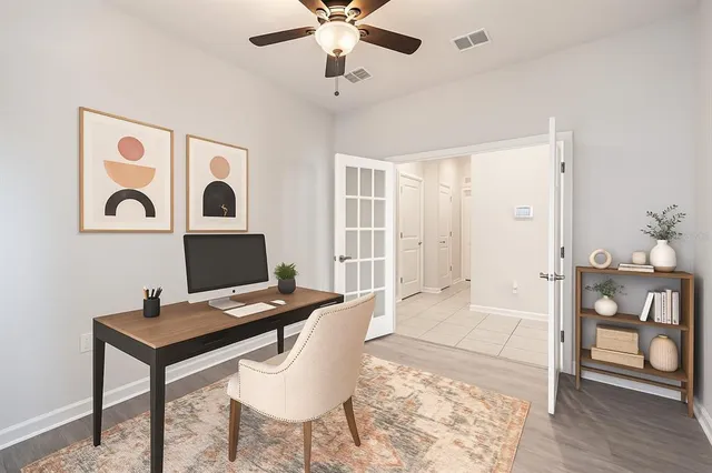 a view of a workspace with furniture and wooden floor