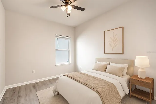 a bedroom with a bed and a lamp