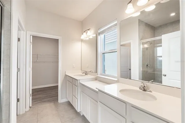 a bathroom with a double vanity sink mirror and double