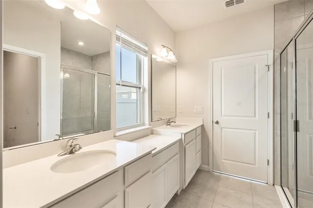 a bathroom with a double vanity sink mirror and double