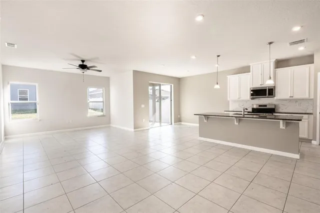 a view of kitchen with stainless steel appliances a refrigerator and a stove top oven