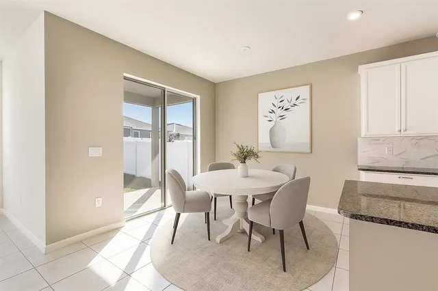 a view of a dining room with furniture and a window
