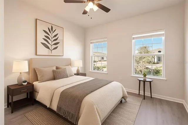 a bedroom with a bed and a painting on the wall