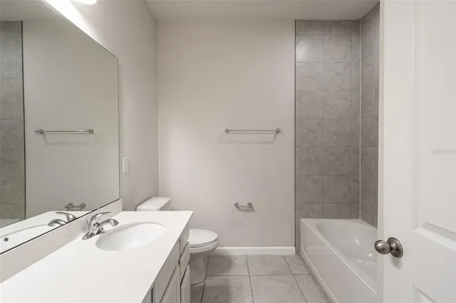 a bathroom with a sink a toilet and bathtub