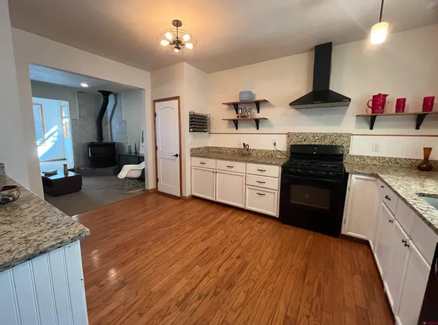 a kitchen with white cabinets and appliances