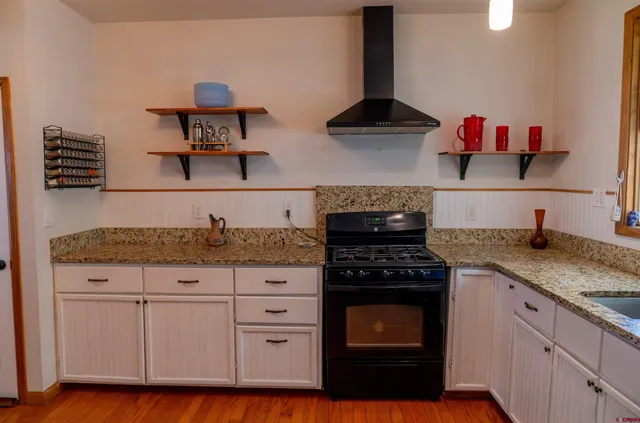 a view of a kitchen with wooden floor